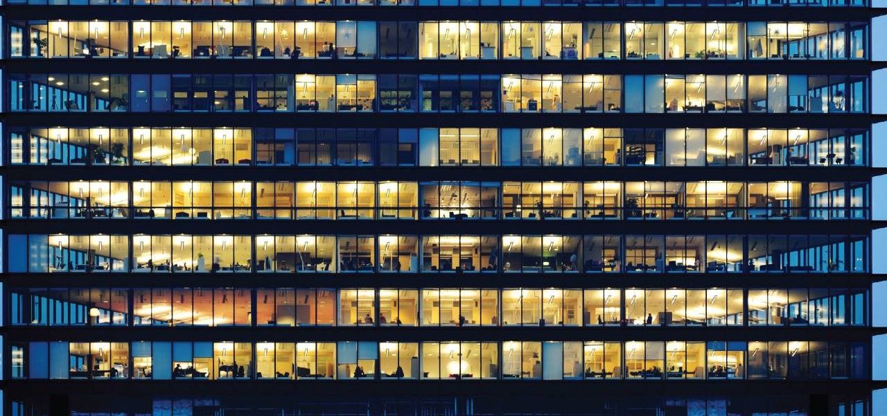 Office building lit up at night.
