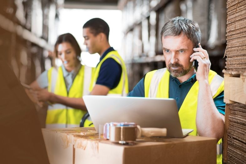 Warehouse manager ringing a supplier