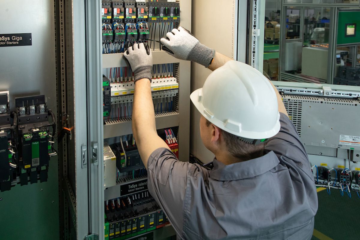 man working on switch panel