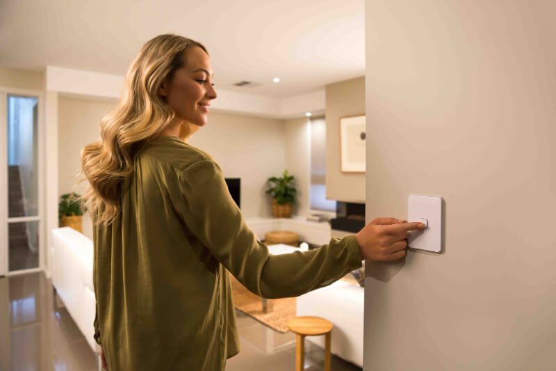 Woman switching on light