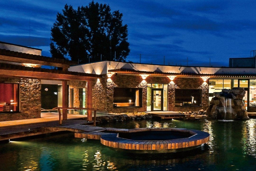 Outside of house with pool and wall lights